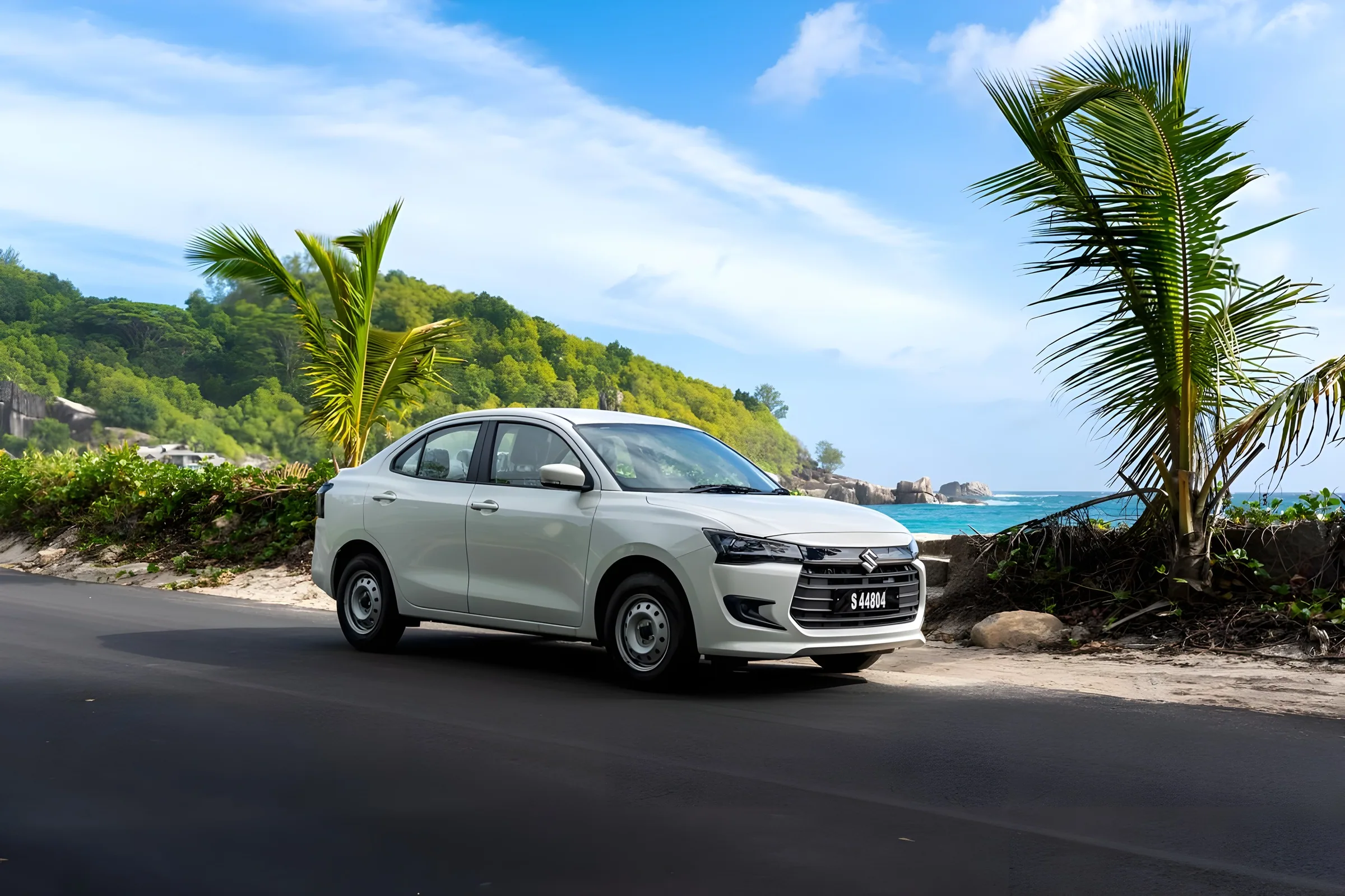 White Suzuki Dzire from the Ekzotik Cars fleet on a beach road with palm trees and turquoise sea