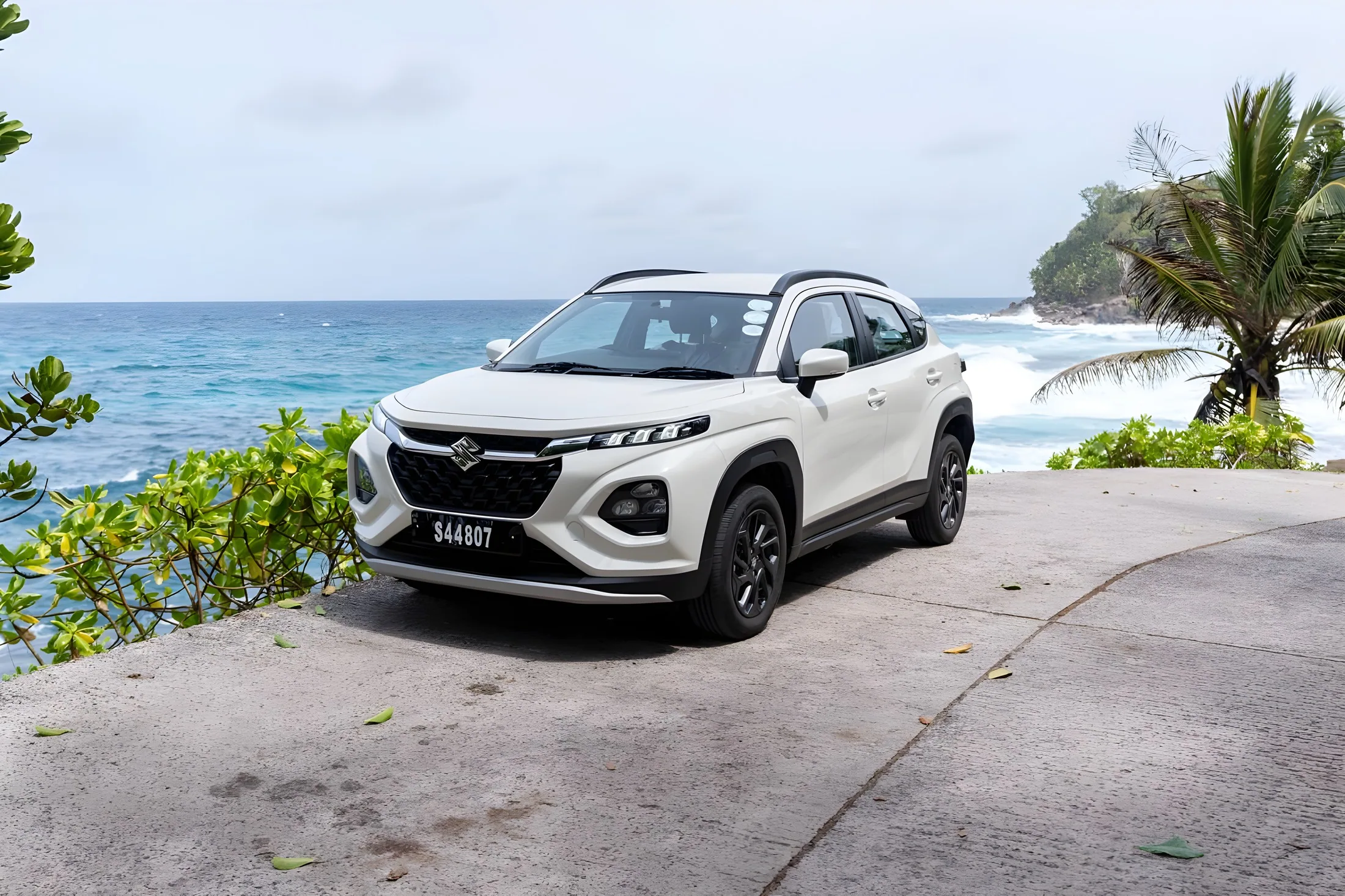 Suzuki Fronx on a headland above the ocean